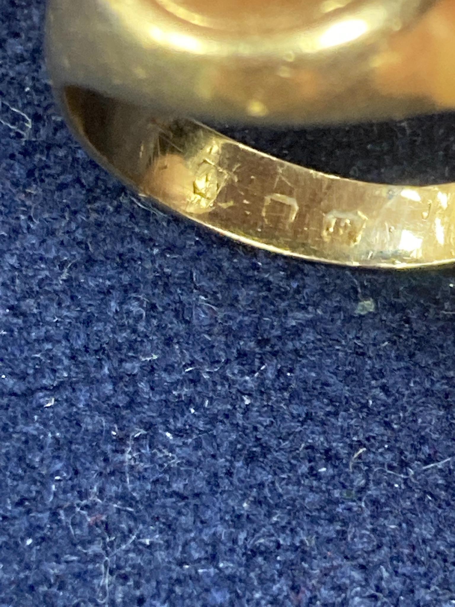 A Victorian yellow metal signet ring with engraved crest, size L, 14.7 grams and three other yellow metal and gem set rings , one a.f. gross 4.1 grams.